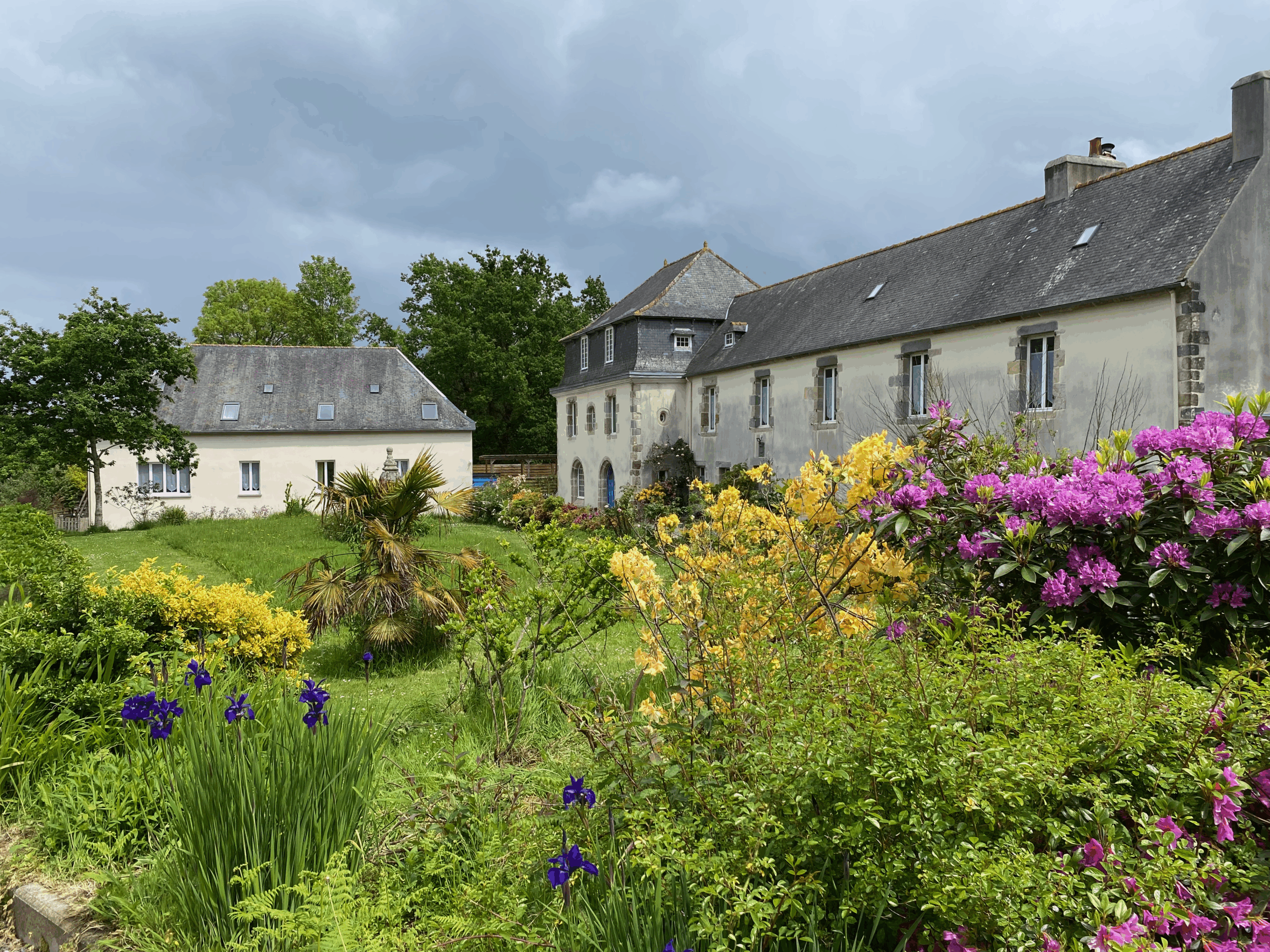 Manor and gite with flowers in the foreground